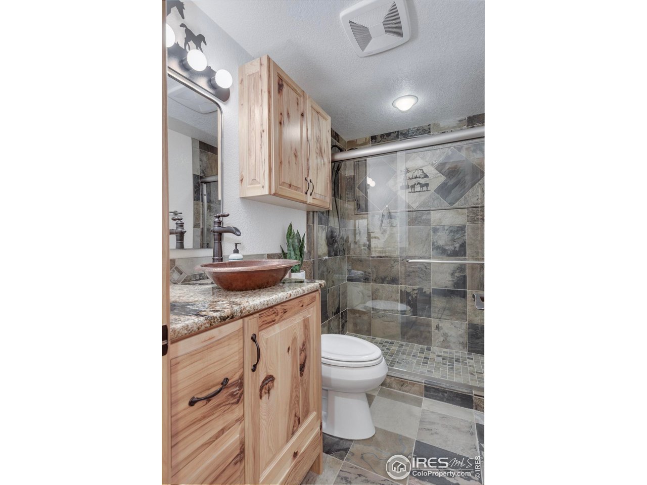 14500 County Road 29 Sterling, CO 80751 - Photo 45 of 49 a bathroom with a granite countertop sink a toilet a mirror and shower