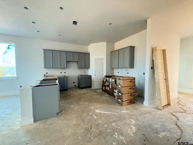 a kitchen with refrigerator and window