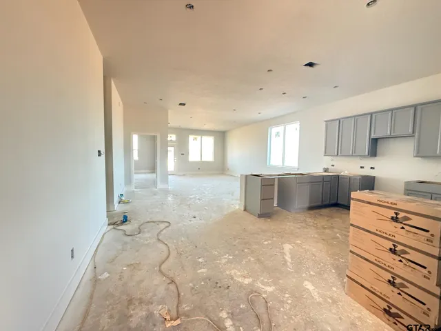 a large white kitchen with cabinets and a stove