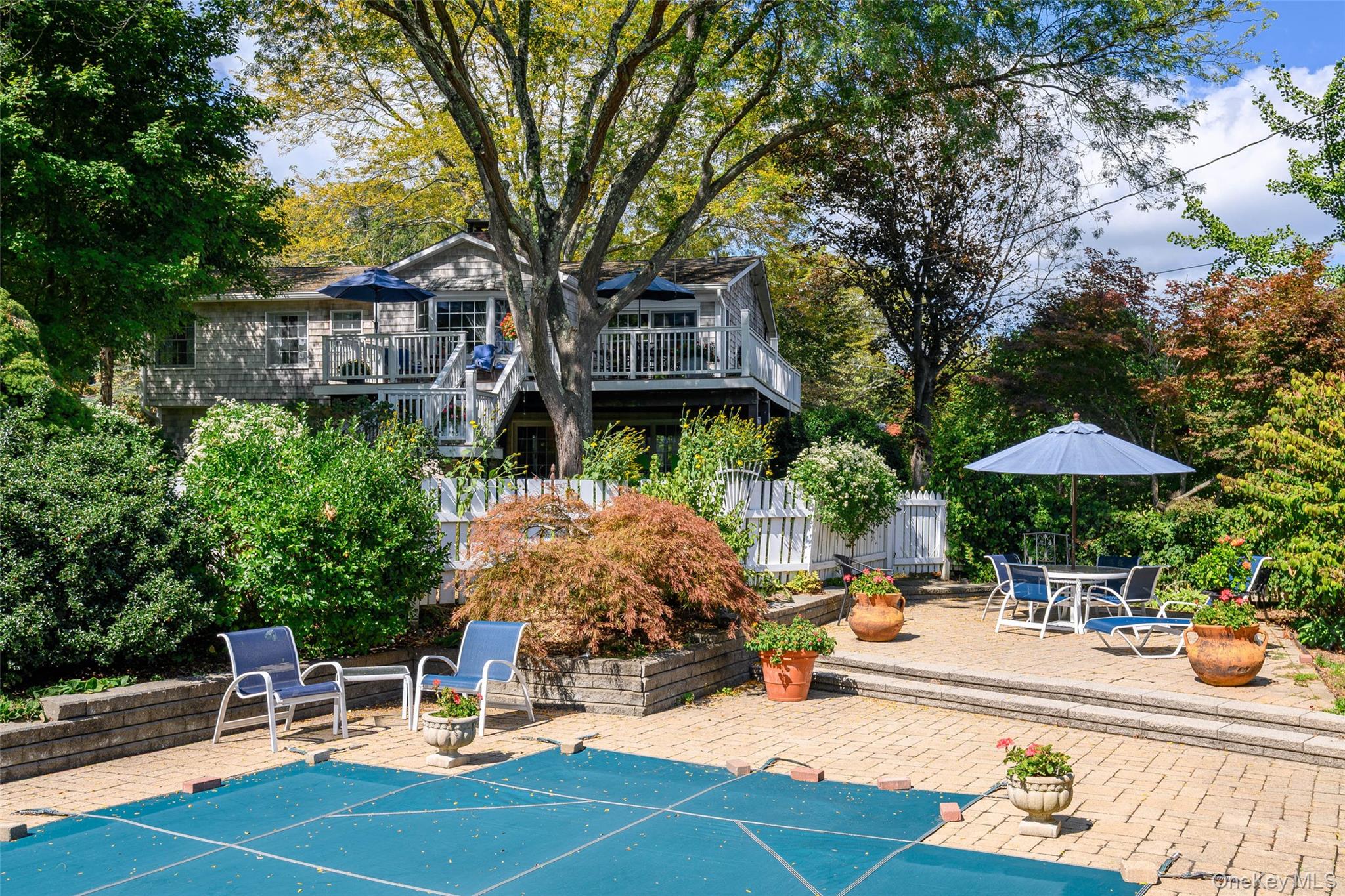 475 Mooney Hill Road Patterson, NY 12563 - Photo 2 of 47 a view of a patio with a table and chairs under an umbrella