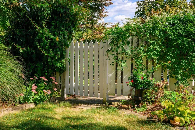 a view of a house with a yard and sitting area