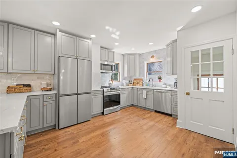 a kitchen with white cabinets and white appliances