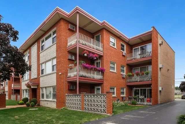 a view of a brick building with many windows