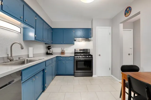a kitchen with stainless steel appliances granite countertop a sink and a stove