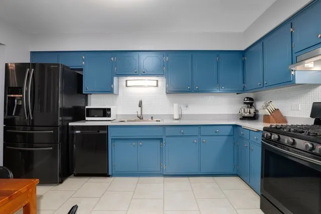 a kitchen with a refrigerator and a stove