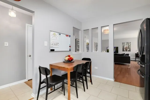 a view of a dining room that has a table and chairs in it