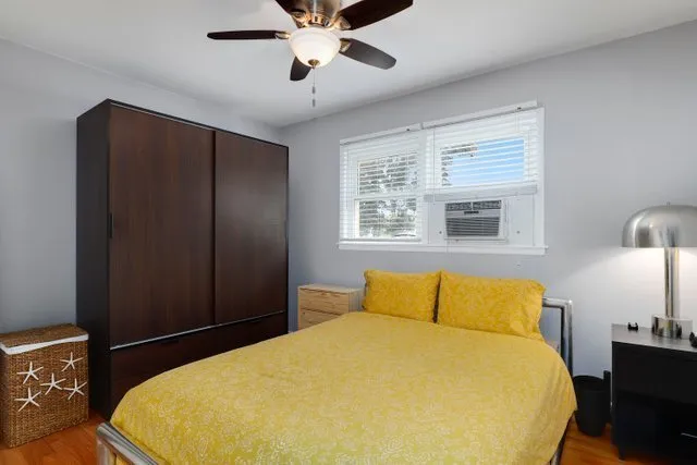a bedroom with a bed and wooden floor