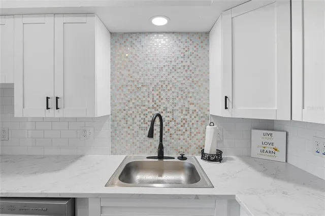 a living room with stainless steel appliances furniture a dining table and chairs