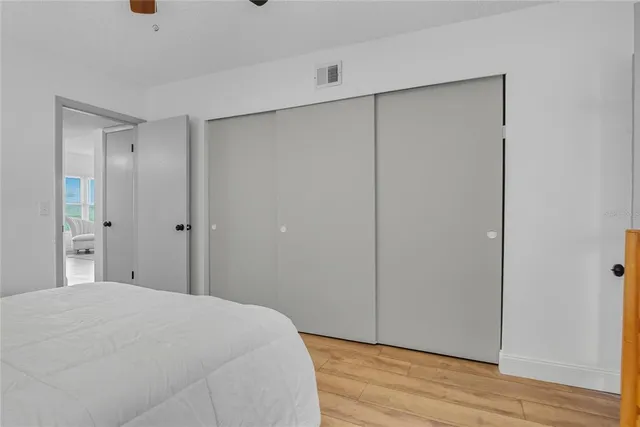 a large bed sitting in a bedroom next to a window