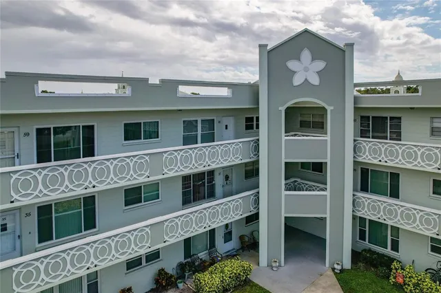 an aerial view of a balcony with chairs and table