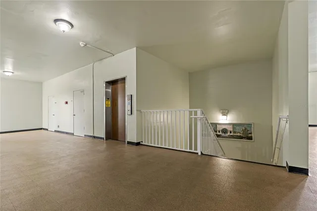 a view of a tennis ground with large trees