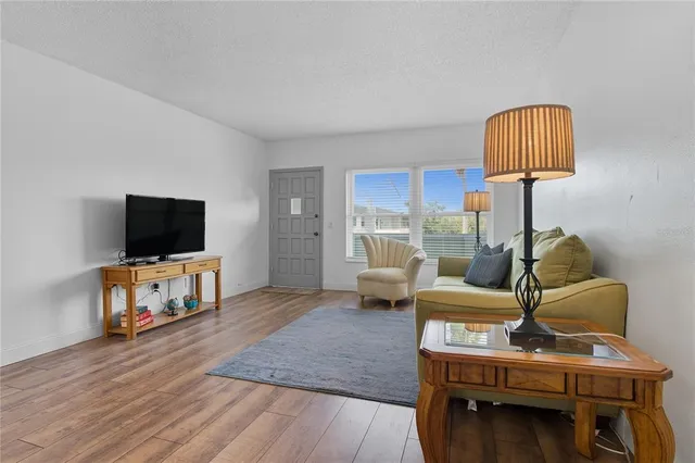 a kitchen with stainless steel appliances granite countertop a sink stove oven and white cabinets