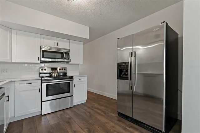 a kitchen with a sink cabinets and stainless steel appliances