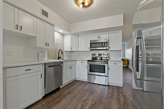 a kitchen with a sink and cabinets