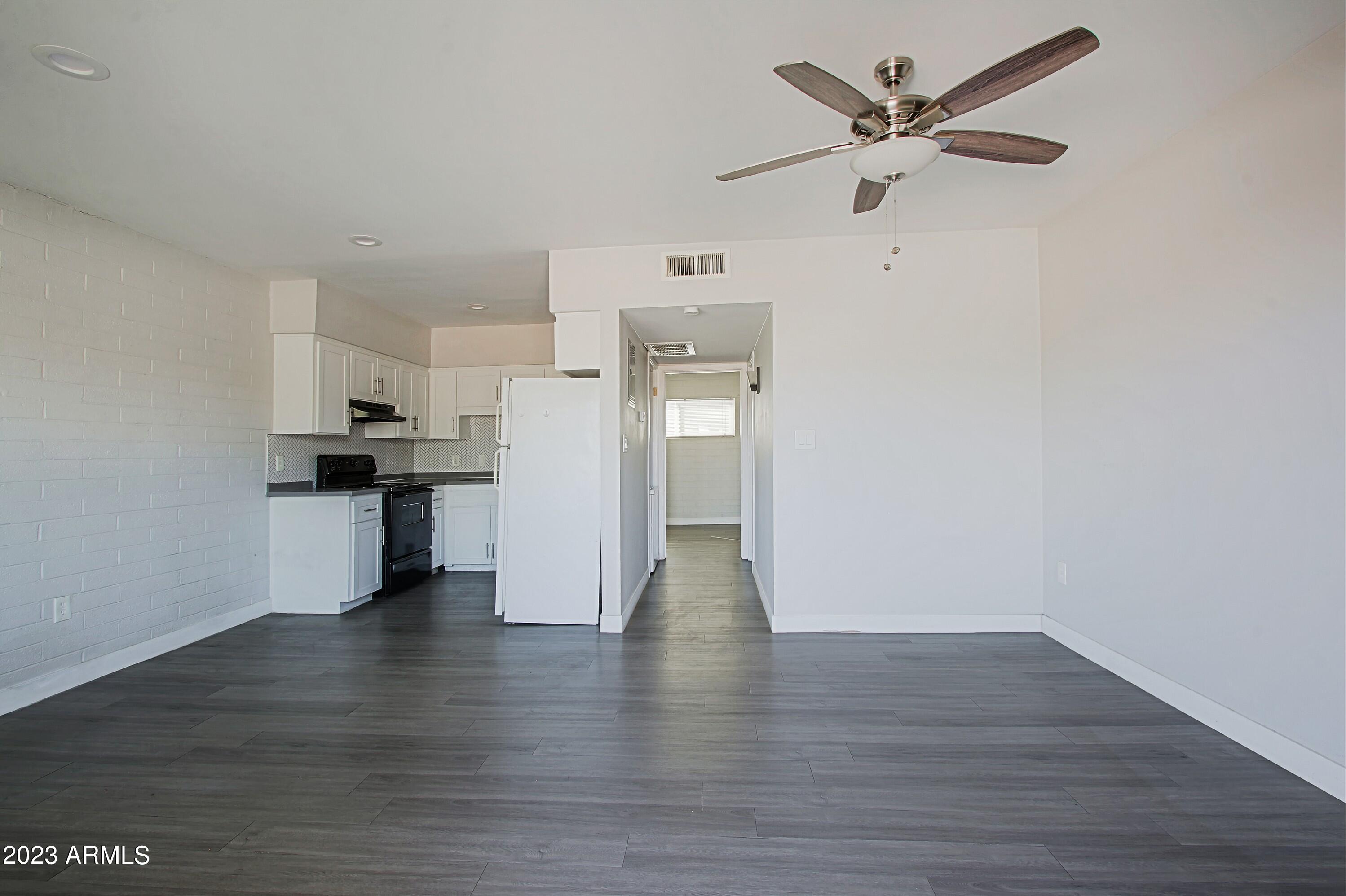 3219 East Earll Drive, Unit 9 Phoenix, AZ 85018 - Photo 2 of 12 a view of a kitchen with a white cabinet and a stove top oven