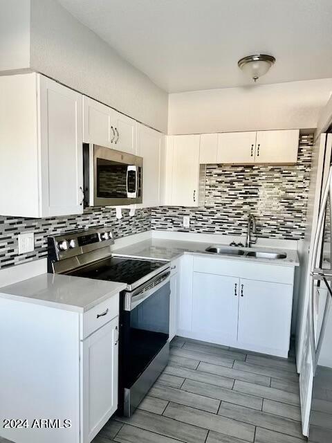 3219 East Earll Drive, Unit 9 Phoenix, AZ 85018 - Photo 4 of 12 a kitchen with granite countertop a sink and a stove