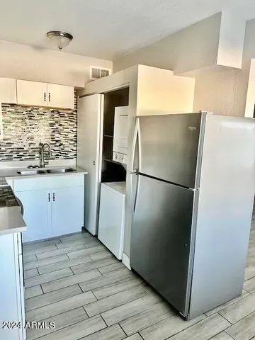 a kitchen with granite countertop a refrigerator and a sink