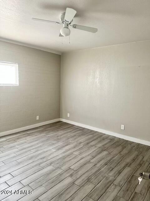 3219 East Earll Drive, Unit 9 Phoenix, AZ 85018 - Photo 7 of 12 a view of an empty room with wooden floor and a window