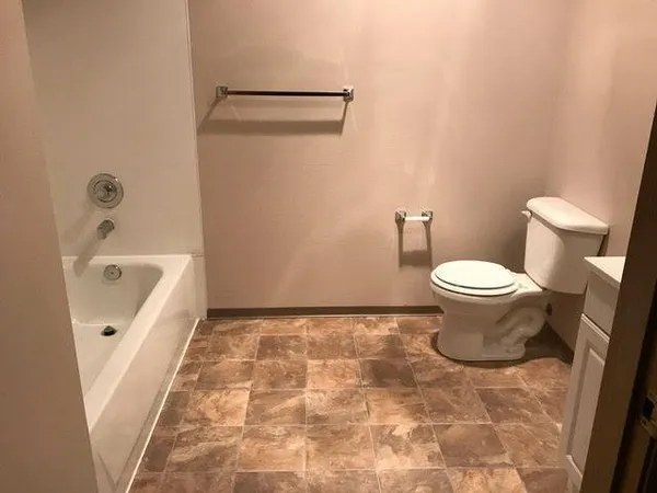 a bathroom with a bathtub and toilet