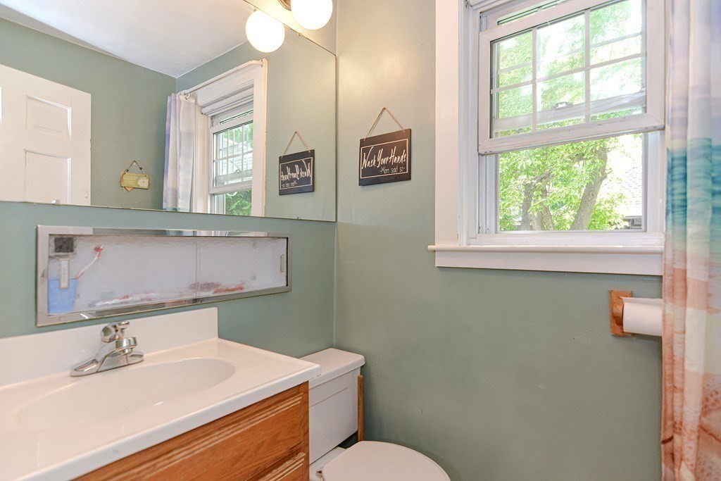 38 Grant Street Milford, MA 01757 - Photo 15 of 42 a bathroom with a sink a toilet and a mirror