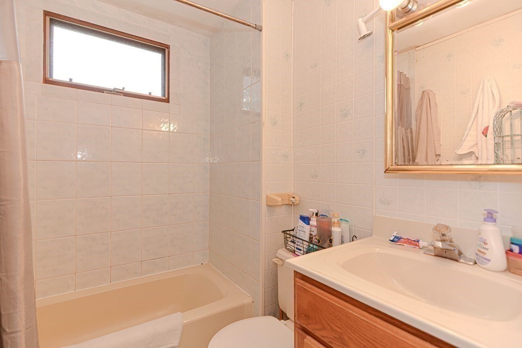 38 Grant Street Milford, MA 01757 - Photo 16 of 42 a bathroom with a sink and a mirror
