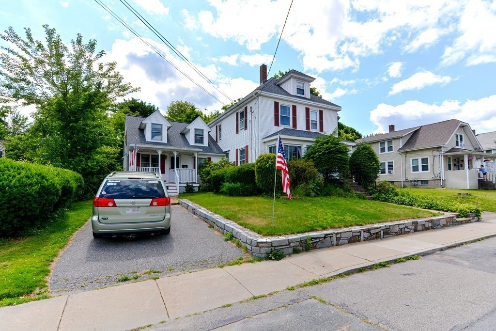 38 Grant Street Milford, MA 01757 - Photo 26 of 42 a car parked in front of a brick house with a small yard