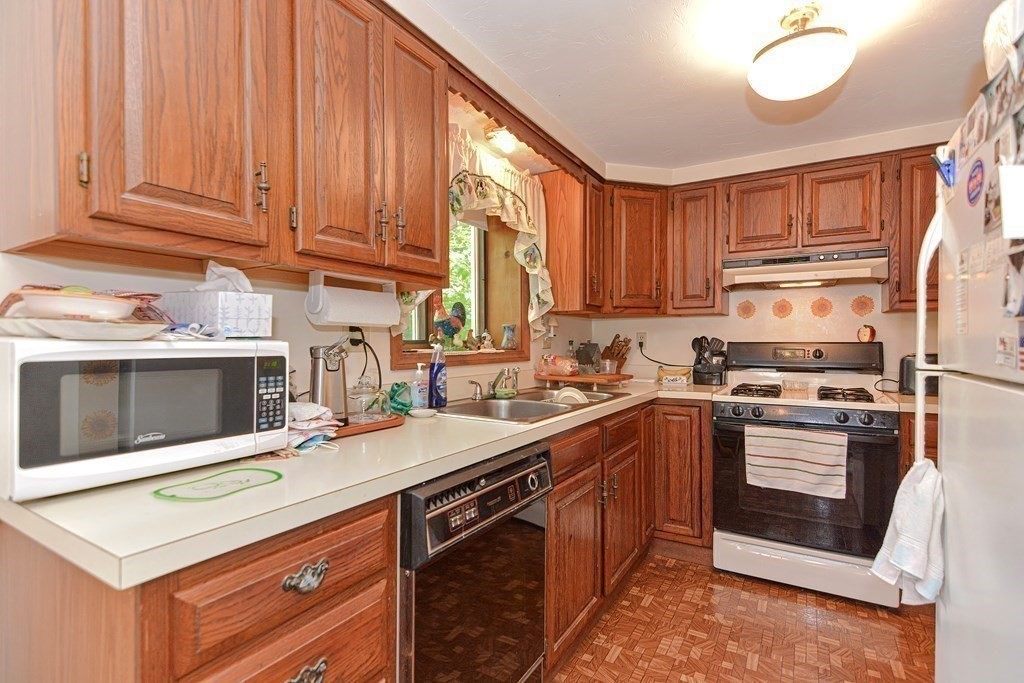 38 Grant Street Milford, MA 01757 - Photo 32 of 42 a kitchen with stainless steel appliances granite countertop a stove a sink and a microwave
