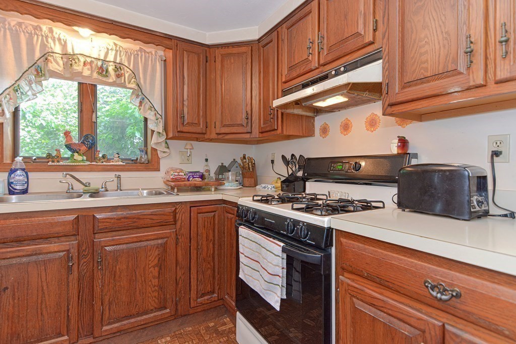 38 Grant Street Milford, MA 01757 - Photo 33 of 42 a kitchen with stainless steel appliances granite countertop a stove sink and cabinets