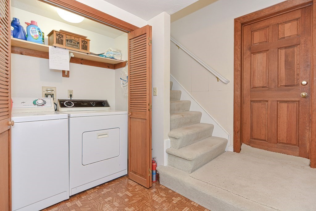 38 Grant Street Milford, MA 01757 - Photo 37 of 42 a view of a hallway with washer and dryer