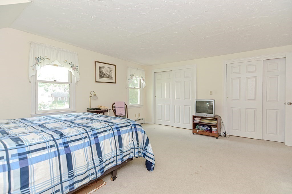38 Grant Street Milford, MA 01757 - Photo 39 of 42 a bed sitting in a bedroom next to a window
