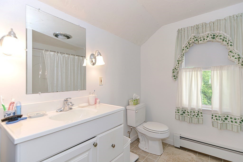 38 Grant Street Milford, MA 01757 - Photo 40 of 42 a bathroom with a sink a toilet and a mirror