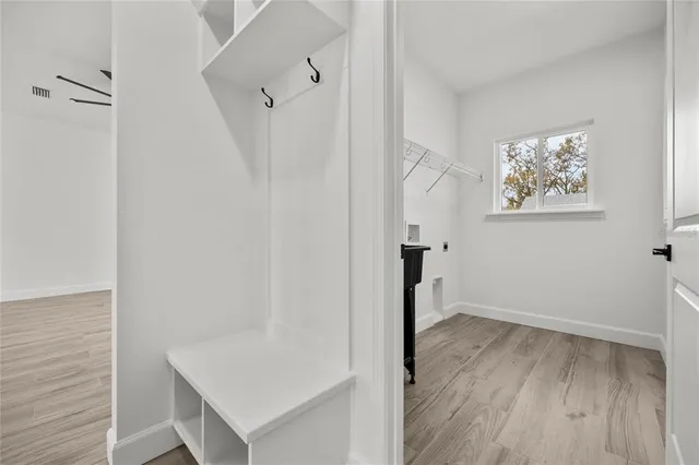 a view of hallway with wooden floor