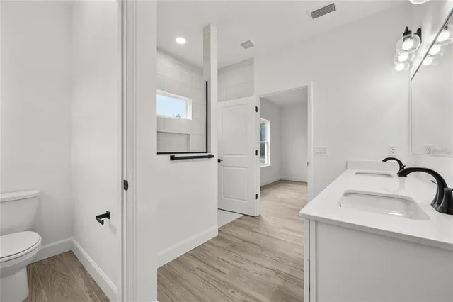 a bathroom with a sink toilet and shower