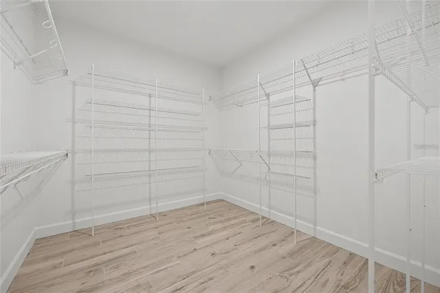 a view of a room with wooden floor