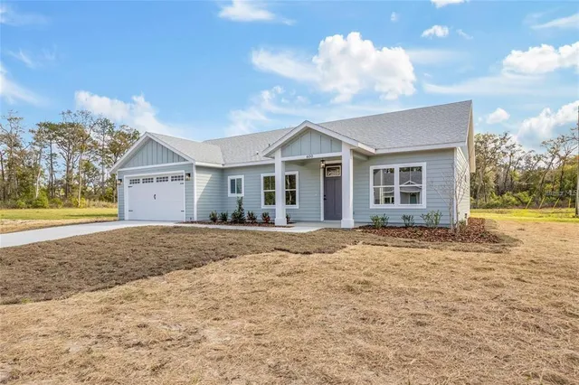 a view of a house with a yard and garage