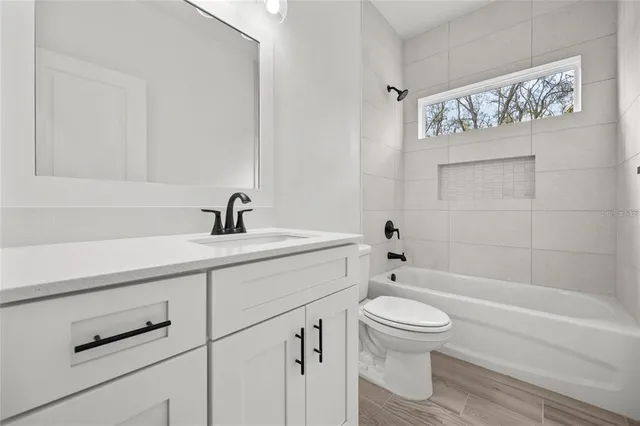 a bathroom with a sink a toilet and a bathtub