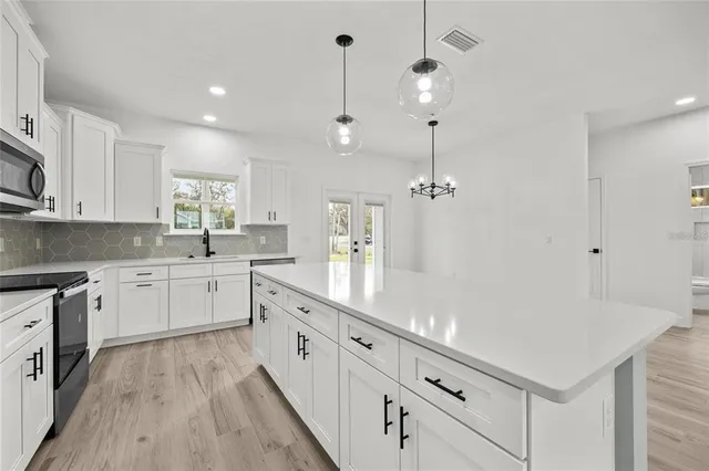 a kitchen with white cabinets and white appliances