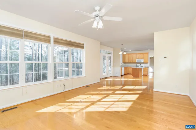 a view of a spacious bathroom with a bathtub windows and a chandelier