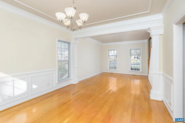 a view of an empty room with a chandelier