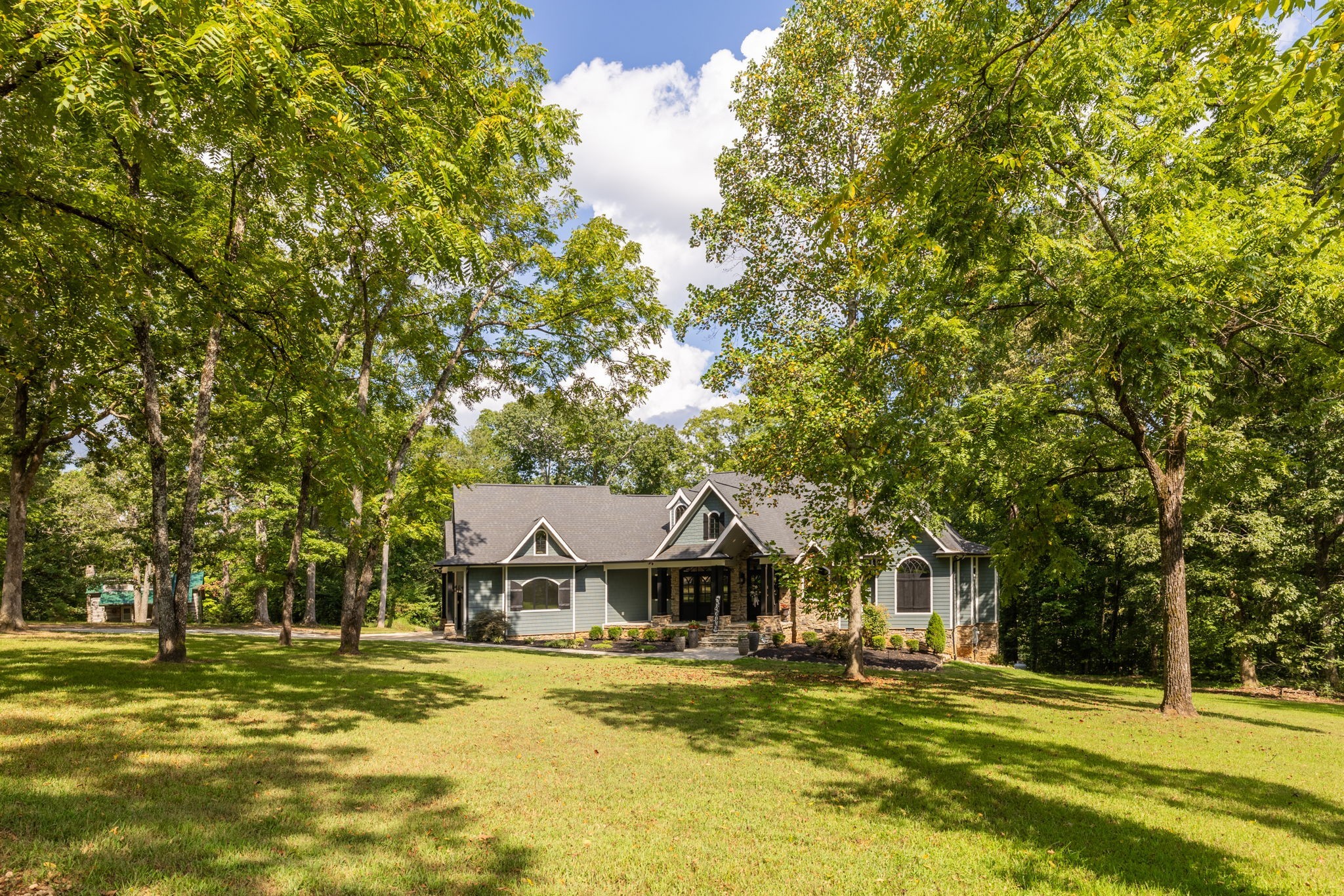 74 Pine Lake Road Summertown, TN 38483 - Photo 4 of 90 a view of a house with a big yard and large trees