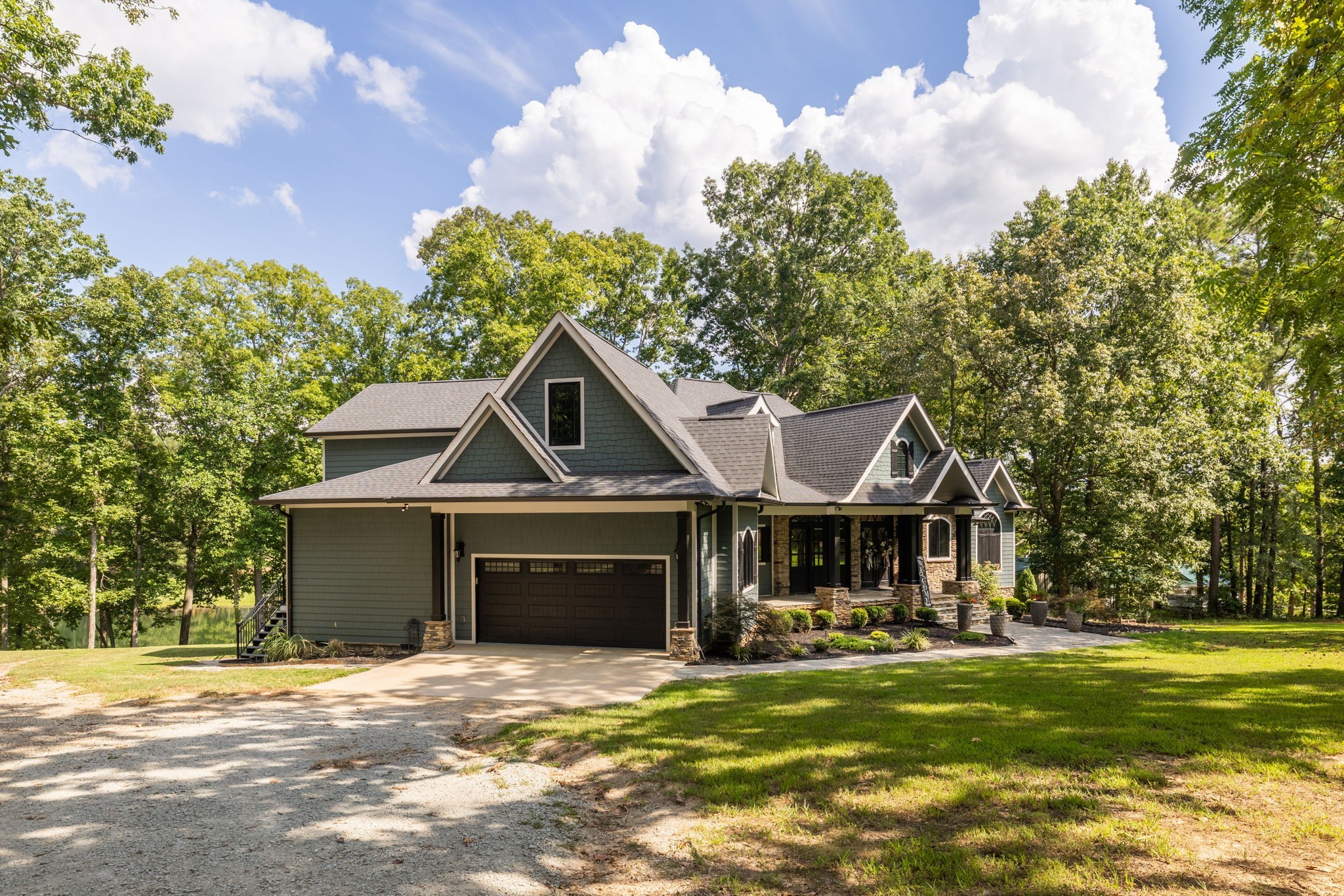 74 Pine Lake Road Summertown, TN 38483 - Photo 7 of 90 a front view of a house with a garden and trees