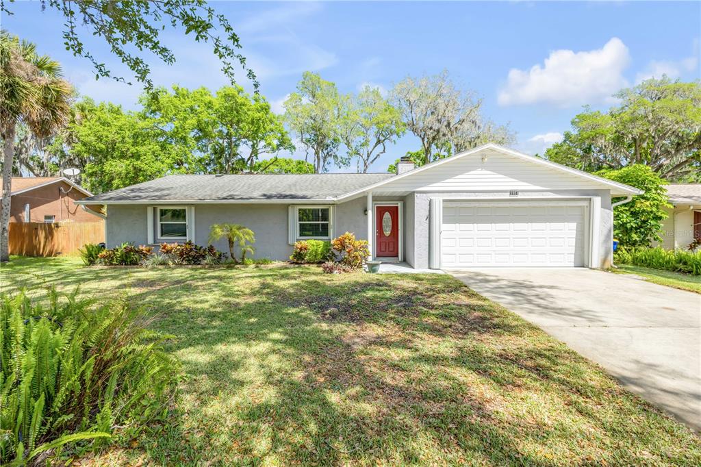 a front view of a house with a yard and garage