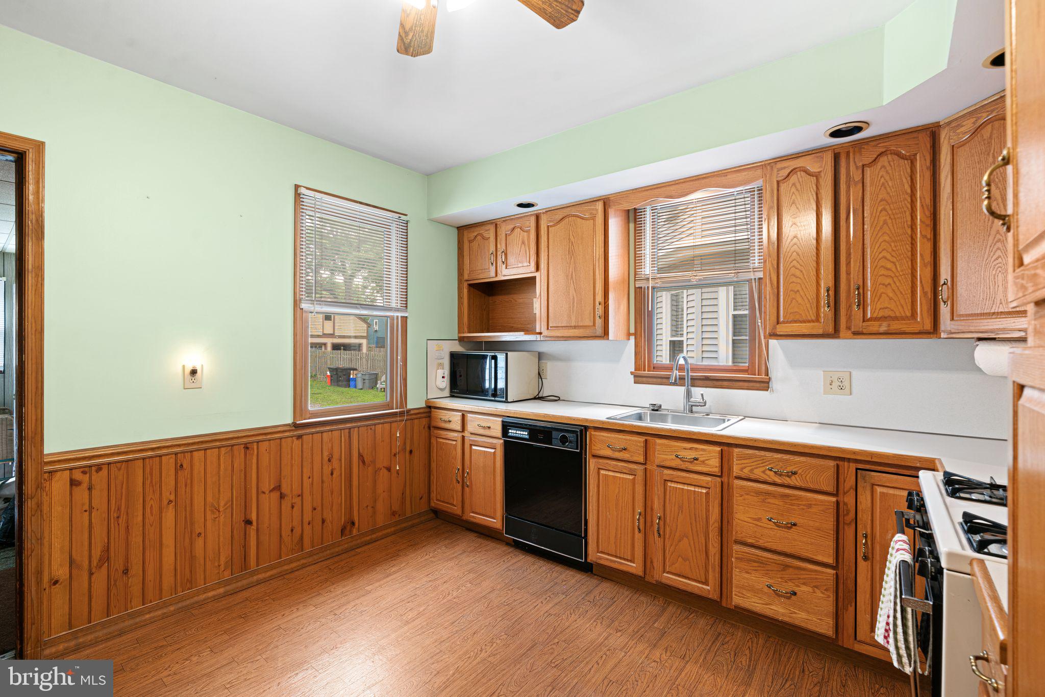 122 West Cottage Avenue Haddonfield, NJ 08033 - Photo 4 of 23 a large kitchen with stainless steel appliances granite countertop a sink and wooden cabinets with wooden floors
