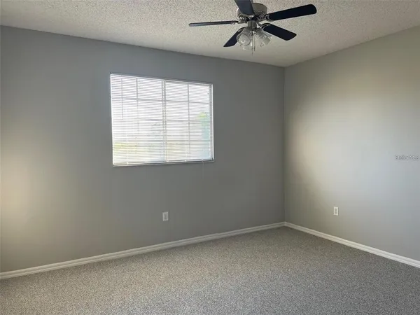 a view of an empty room and a window