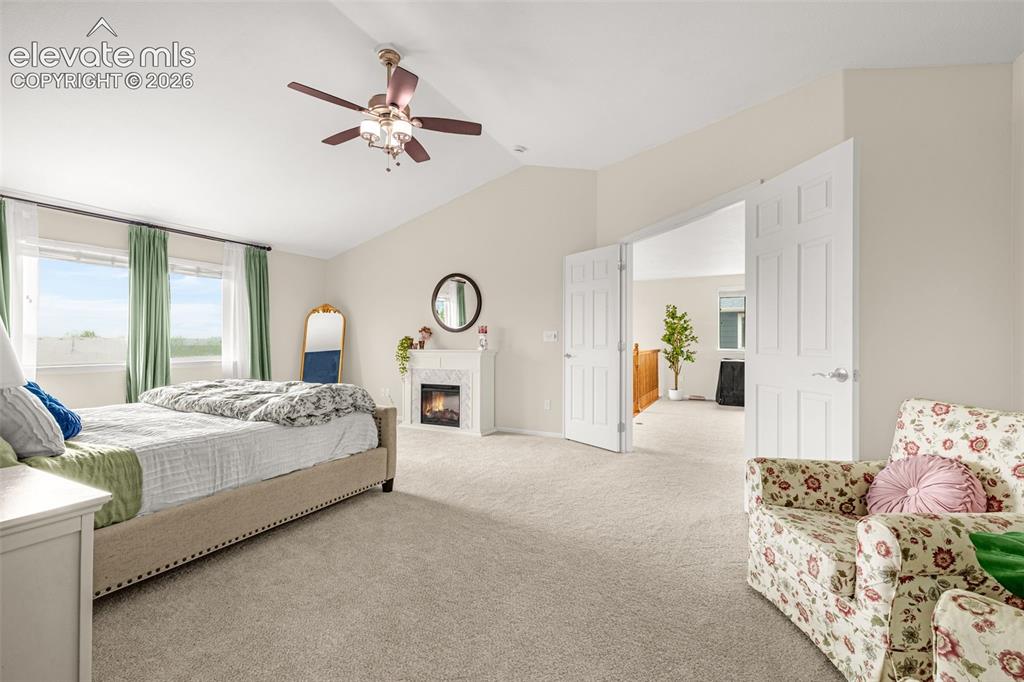 9127 Oakmont Road Peyton, CO 80831 - Photo 20 of 49 a spacious bedroom with a bed and window