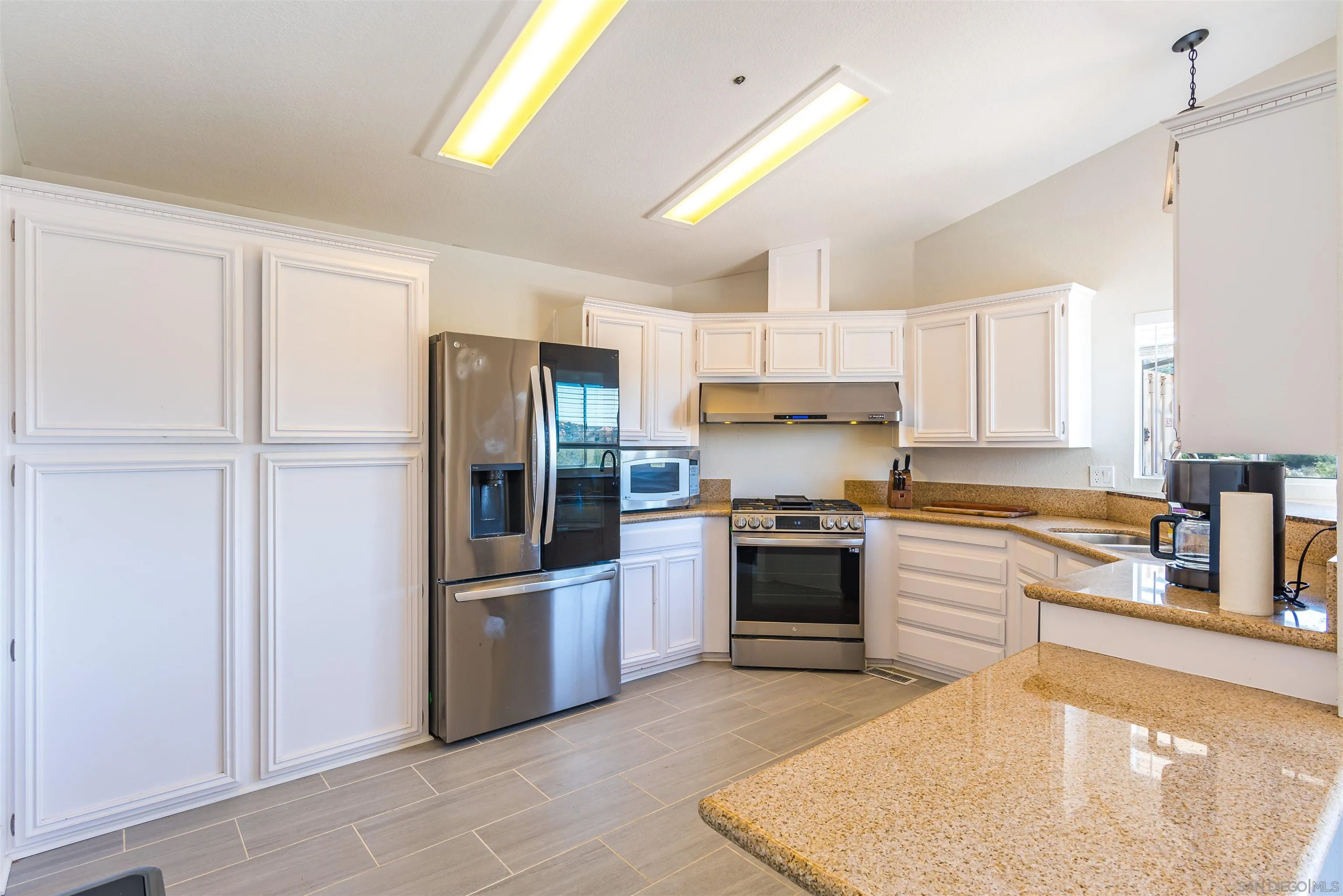 19150 High Glen Road Alpine, CA 91901 - Photo 27 of 56 a large kitchen with stainless steel appliances granite countertop a refrigerator and a stove top oven