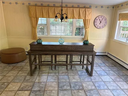 a view of a dining room with furniture and a window