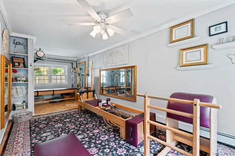 a reading room with furniture rug and window