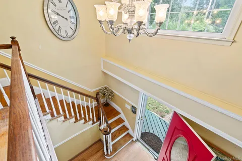 a view of stairs with furniture and a window