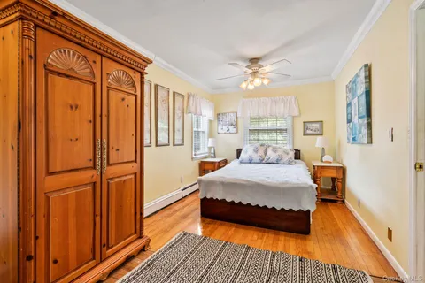 a spacious bedroom with a bed and a chandelier